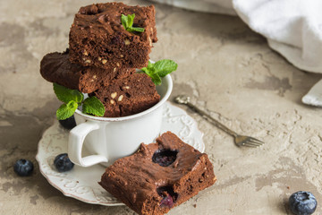 Chocolate brownie with peanuts,blueberries and mint in a white Cup