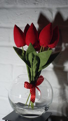 Decorative red tulips in a glass vase
