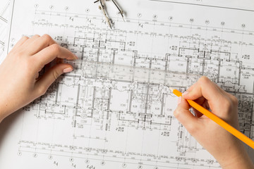 Hands of an architect-designer working on a project