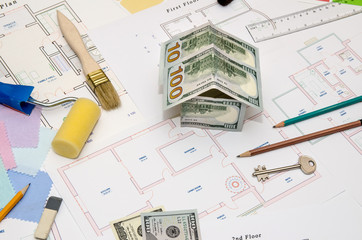 architectural drawings for houses with dollar, paints, brushes and accessories