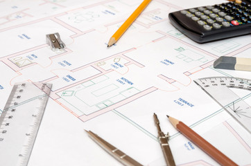 House plans with calculator, pencil, ruler, compass