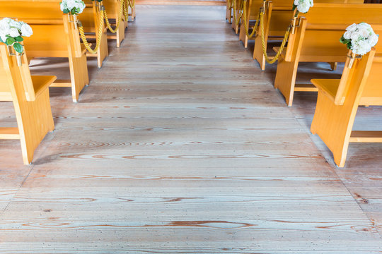 church interior with empty wooden pews.