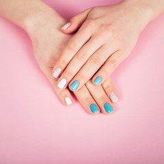 beautiful manicure. gel polish coating in white and turquoise, stamping.