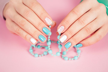 beautiful manicure. gel polish coating in white and turquoise, stamping.