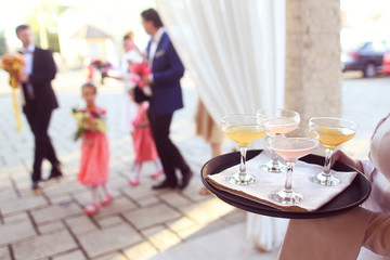 Waiter with glasses of cocktails on tray