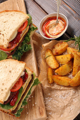 Sandwich with beef, vegetables and baked potatoes.