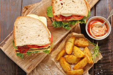 Sandwich with beef, vegetables and baked potatoes.