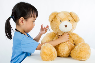 Asian Little Chinese Girl Playing Doctor with Teddy Bear