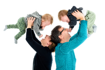 Happy family with adopted twins is laughing. Isolated on white.