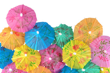 Colorful paper cocktail umbrellas close-up on a white