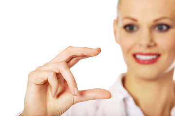 Young businesswoman showing copy space or something between fingers