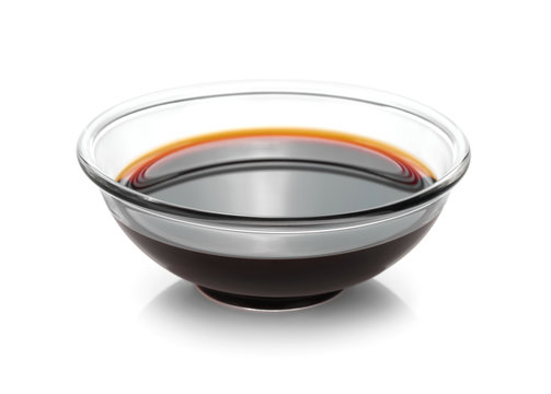 Bowl with soy sauce isolated on white background.