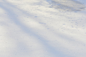 Fototapeta na wymiar Shadows on the snow cover natural background