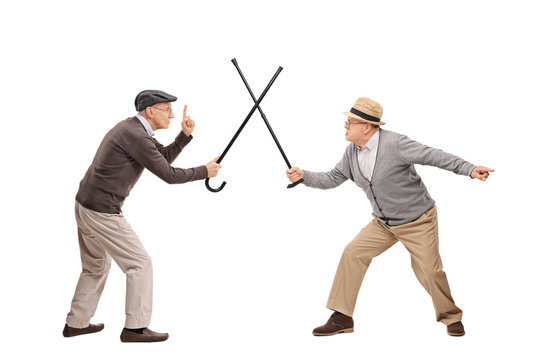 Two senior man in a sword fight with canes
