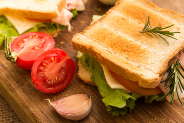 Toasted sandwich with bacon, cheese, tomato and lettuce