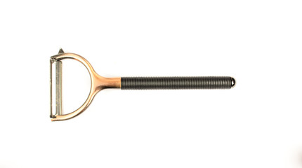 old potato peeler on white background / peeler peelings a potato / potato knife