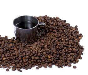 the scattered coffee grains and steel mug