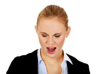 Angry young business woman screaming 