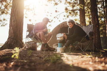 Couple cooking food outdoors on a camping trip