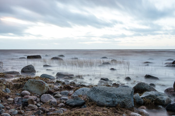 Sunset at the sea shore of a beach with rocks