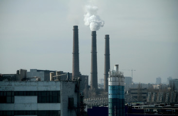 Urban industrial landscape with smoking factory smokestacks 