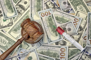Judges Gavel And Syringe With Injection On Dollar Cash Backgroun
