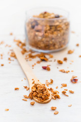 Healthy breakfast. Granola in a wooden spoon on a white backgrou