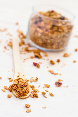 Healthy breakfast. Freshly granola in a wooden spoon on a white 