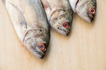 Fresh sea fish on wooden table