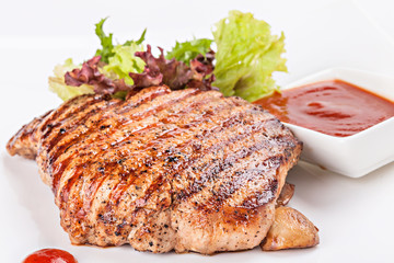 Mignon grilled on plate with with garnish of vegetables and sauc