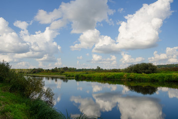 view to river with  cloudy sky