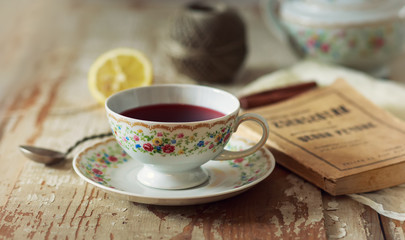 Cup of tea on wooden table. vintage scene.