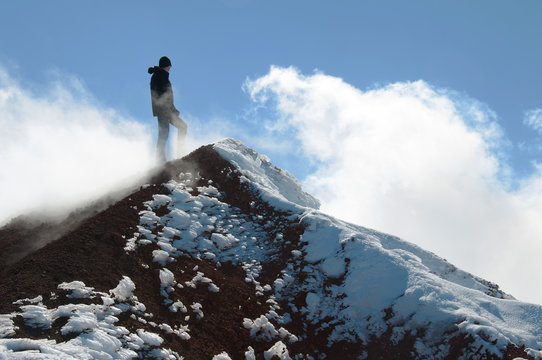 Tourist stands on the summit of Avacha volcano