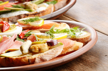 Open sandwiches with salmon, eggs, mussels and jamon