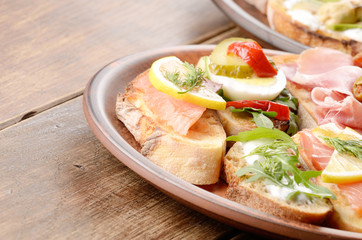 Open sandwiches with salmon, eggs, mussels and jamon
