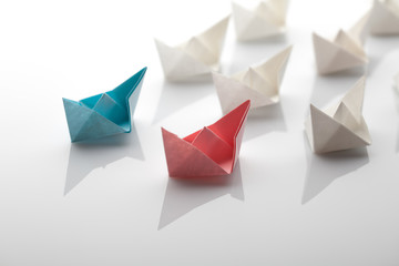 Leadership concept using blue paper ship 