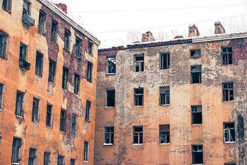 Fototapeta premium Old abandoned buildings wall with empty windows