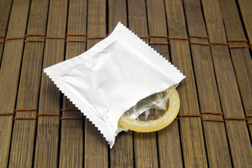 One condom on wooden background