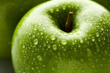 apple in green with water drops on its surface