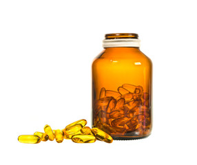 Vitamin D bottle with spilled contents on white background