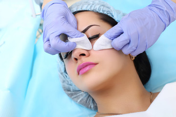 Naklejka premium Professional cleansing of acne in a beauty salon.