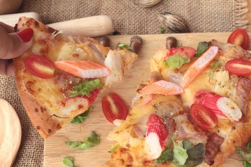 Italian pizza is delicious on wood background.