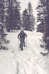 Unidentifiable snowshoe hikers moving up hill