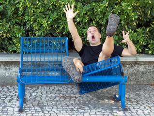 man on a bench falling down