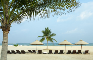 Lounger under an umbrella on the beach ocean