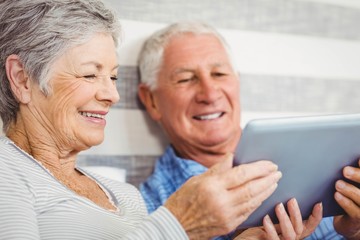 Senior couple using digital tablet