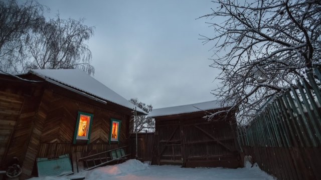 Night to day time lapse of the winter garden with wooden house