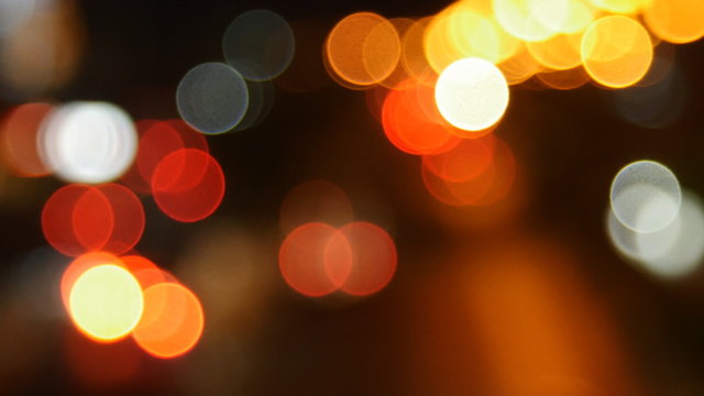 Beautiful bokeh background on dark, out of focus lights during the night