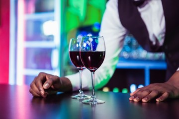 Two glasses of wine on bar counter