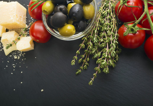 cheese with fresh herbs, black and green olives, cherry tomatoes